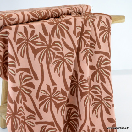 Tissu Viscose motif palmiers exotiques fond pêche