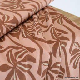 Tissu Viscose motif palmiers exotiques fond pêche