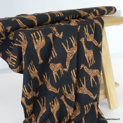 Tissu popeline de Viscose motif girafes fond noir