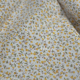 Popeline de coton motif petites fleurs jaunes fond écru - Emma