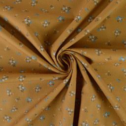 Popeline de coton Bisou motif fleurs bleues fond Ocre